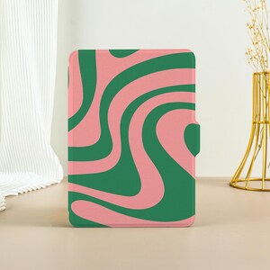 May include: An e-reader cover with a swirling abstract pattern in pink and green.
