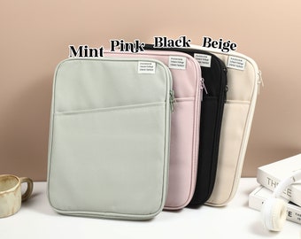 May include: Four zippered pouches in mint, pink, black, and beige. Each pouch has a zipper closure and a small pocket on the front. The pouches are made of a soft, canvas-like material. The text "Fashion Leisure College Classic Version" is printed on the front of each pouch.