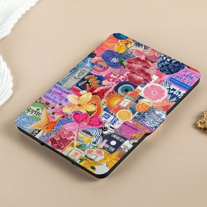 May include: A black e-reader case with a colorful collage design. The design includes images of fruit, flowers, fish, lips, and text such as 'Sprite', 'Gin', 'Rima', 'Sardine', 'Love Forever', and 'New York'. 
