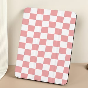 May include: A pink and white checkered iPad case. The case is made of a soft, durable material and has a sleek, modern design.