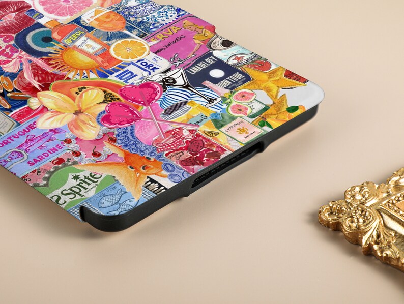 May include: A colorful phone case with a collage of images including a papaya, a goldfish, a star, a lollipop, a bottle of champagne, a bottle of gin, a lemon, a glass of wine, a bottle of soda, a cherry, a fish, a sun, a pineapple, a bottle of liquor, a grapefruit, a bottle of water, and a bottle of juice. The case is black and has a textured surface.