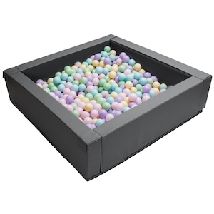 May include: A grey square ball pit filled with pastel coloured balls. The pit is made of soft, padded material.