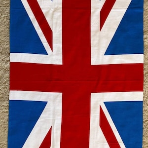 May include: A blue, red and white beach towel with the Union Jack flag design.
