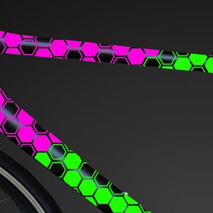 May include: A black bicycle frame with a pink and green honeycomb pattern.