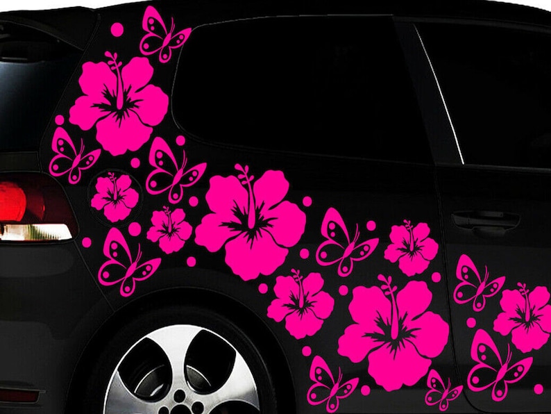 May include: A black car with pink hibiscus flower and butterfly decals on the side. The decals are in a vertical line and are arranged in a random pattern.