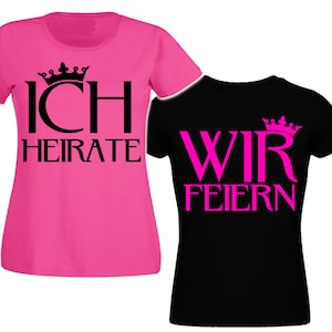 Könnte beinhalten: Zwei T-Shirts, eines pink und eines schwarz, mit dem Text "ICH HEIRATE" auf dem pinken Shirt und "WIR FEIERN" auf dem schwarzen Shirt. Beide Shirts haben ein Kronenmotiv.