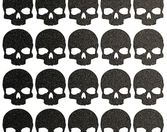 May include: Twenty-four black glitter skull stickers. The skulls have a simple design with two eye sockets, a nose, and a mouth.