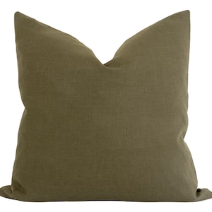 May include: A solid green linen pillow cover. The pillow cover is made of a soft, natural fabric and has a simple, elegant design.