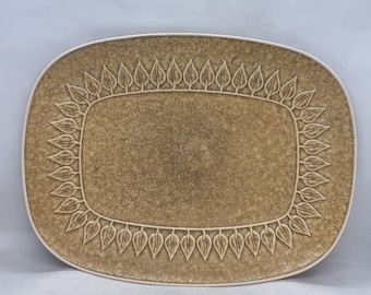 May include: A rectangular ceramic serving platter with a brown glaze and a leaf design around the edge.