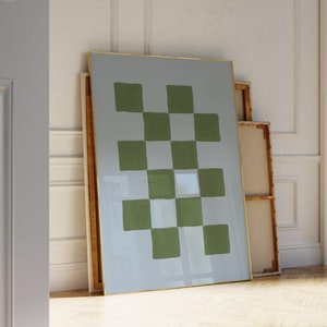May include: A framed abstract painting with a checkered pattern in shades of green and white on a light blue background.