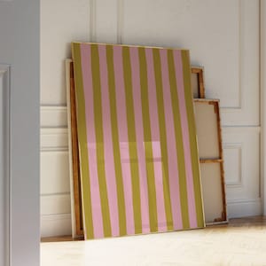 May include: A large framed canvas print with vertical stripes in pink and olive green.