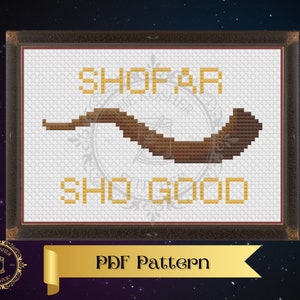 May include: A cross-stitch pattern featuring a brown shofar with the words "Shofar Sh'good" in yellow.