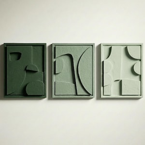 May include: Three rectangular wall art panels arranged horizontally. Each panel features a unique raised geometric relief pattern in varying shades of green, ranging from a deep forest green to a light sage and a pale mint green finish.