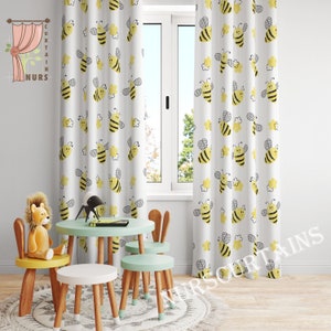 May include: White curtains with a yellow bee pattern. The curtains are hung in a room with a small table and chairs. The room is decorated with a stuffed lion.