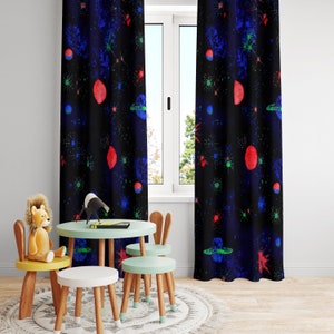 May include: Two black curtains with a glow-in-the-dark space-themed print. The print features red, blue, and green stars, planets, and spaceships on a black background.