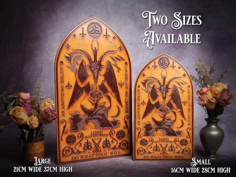 May include: Two wooden plaques with a dark brown background and gold accents. The plaques feature a stylized image of a goat-like figure with wings and horns. The text "AS ABOVE SO BELOW" is written on the plaques, along with the phrase "DO WHAT THOU WILL". The plaques are available in two sizes: 21cm wide x 37cm high and 16cm wide x 28cm high.