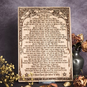 May include: A wooden plaque with a burnt-in design of a poem titled "The Wiggan Rede". The poem is about Wiccan laws and traditions. The plaque is decorated with a star and a circle.
