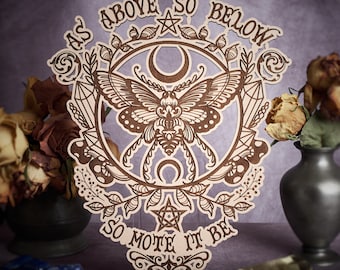 May include: A wooden wall hanging with a brown moth, crescent moons, and a pentagram. The text "As Above So Below So Mote It Be" is inscribed around the moth.