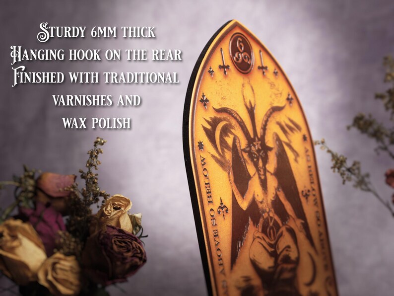 May include: A wooden plaque with a dark brown image of a goat-headed figure with wings and a pentagram. The plaque is 6mm thick and has a hanging hook on the back. The text on the plaque reads "MOTHER OF THE BLACK", "ALL HAIL COW FROM THE VOID", and "666".