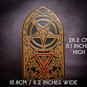 May include: A black and gold decorative plaque with a pentagram and other symbols. The plaque is 28.2 cm high and 15.8 cm wide.