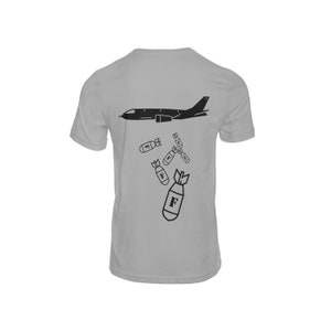 May include: A gray t-shirt with a black silhouette of a plane dropping bombs. The bombs are labeled with the letter "F".