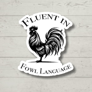 May include: A black and white sticker with a rooster illustration and the text "Fluent in Fowl Language".