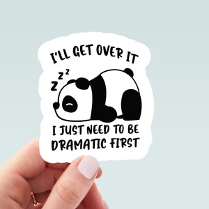 May include: A white sticker with a black and white panda bear illustration. The text on the sticker reads "I'll get over it. I just need to be dramatic first."