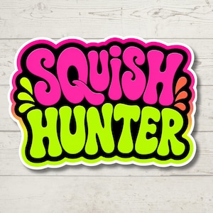 May include: A die-cut sticker featuring the text SQUISH HUNTER in a bold, rounded, retro-style font. The word SQUISH is in bright pink, and the word HUNTER is in lime green. The design includes a thick black outline and small decorative accents.