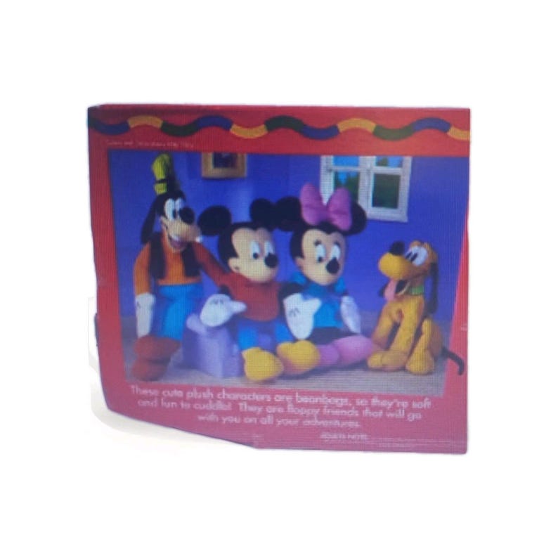 May include: A colorful image featuring plush characters of Mickey Mouse, Minnie Mouse, Goofy, and Pluto. The characters are seated in a room setting. Text at the bottom reads, "These cute plush characters are beanbags, so they're soft and fun to cuddle!"