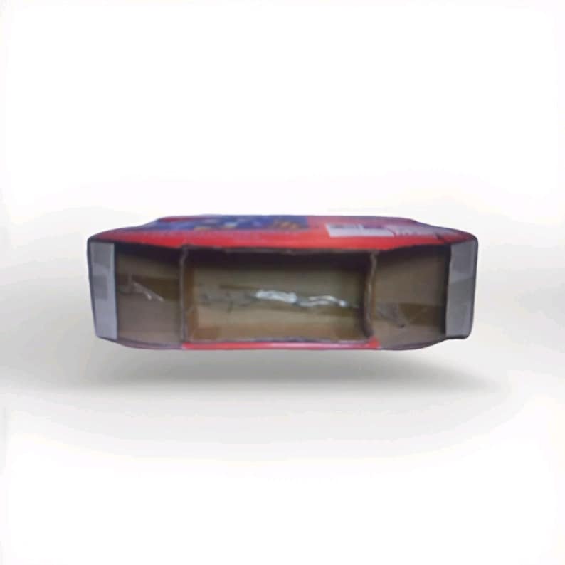 May include: A partially open, rectangular cardboard box with a red top and gray sides. The box has a visible interior and appears to be empty. The top of the box has some visible text and graphics.