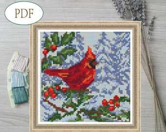 May include: A red cardinal bird perched on a holly branch with red berries. The bird is surrounded by a snowy background with blue and white tones.