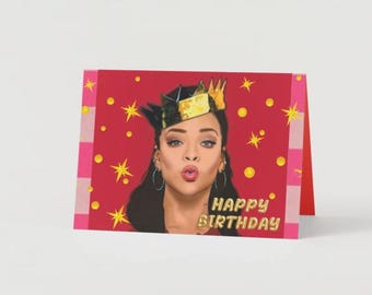 May include: A red birthday card with a woman wearing a gold crown and a red background with gold stars and dots. The text "Happy Birthday" is in gold letters.