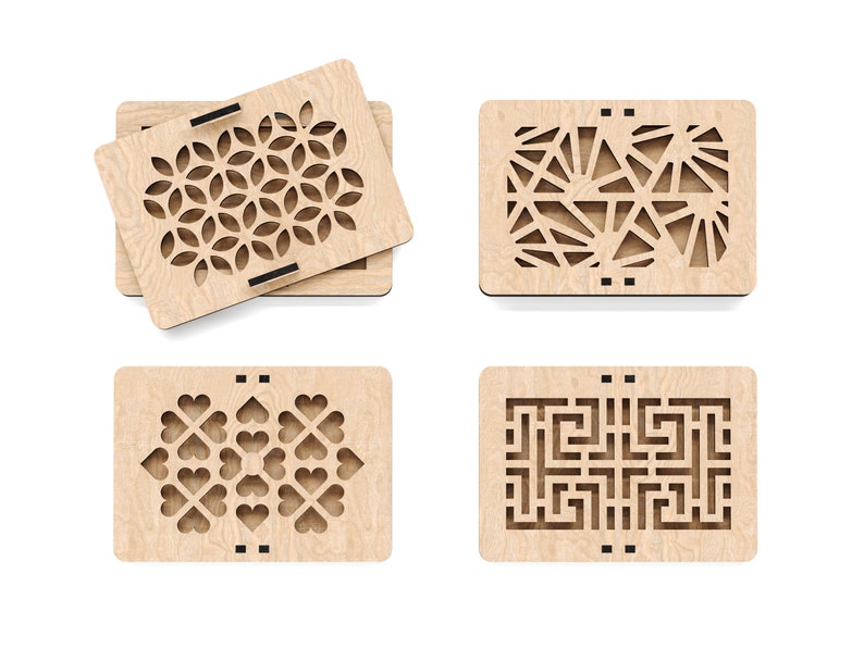 May include: Four wooden boxes with intricate laser-cut designs. The designs include a geometric pattern, a sunburst pattern, a heart pattern, and a maze pattern.