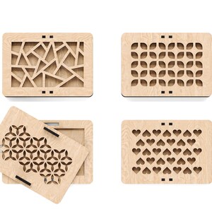 May include: Four wooden boxes with different laser cut designs. The boxes are made of light wood and have a natural finish. The designs include geometric shapes, flowers, and hearts.