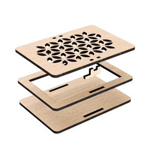 May include: A wooden box with a geometric pattern cut out of the top. The box is made of three pieces that fit together.