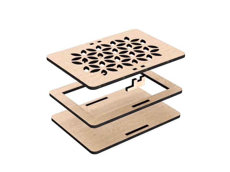 May include: A wooden box with a geometric pattern cut out of the top. The box is made of three pieces that fit together.