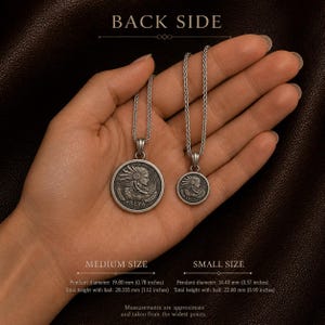 May include: Two silver-toned circular pendants on chains, labeled BACK SIDE. The medium pendant is 0.78 inches in diameter and 1.12 inches high with bail. The small pendant is 0.57 inches in diameter and 0.90 inches high with bail. Both feature a relief of Freya.