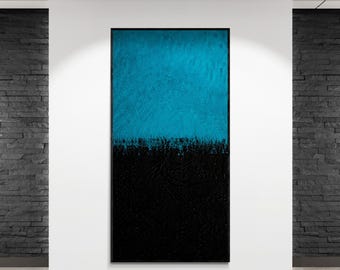 May include: Abstract wall art featuring a textured surface. The upper half is a vibrant teal, transitioning to a deep black at the bottom. The artwork is framed in black and mounted on a white wall.
