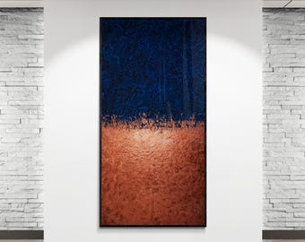 May include: Abstract wall art featuring a textured design. The top half is a deep navy blue, while the bottom half is a warm copper color. The artwork is displayed in a modern white room with track lighting.