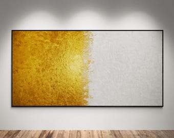May include: A rectangular framed artwork with a split design. The left side features a textured gold surface, while the right side is a textured white. The artwork is displayed on a white wall above a wooden floor.