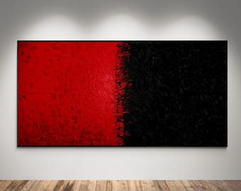 May include: Abstract art piece with a bold design. The artwork is divided into two distinct halves: a vibrant red on the left and a textured black on the right. The piece is framed in black and mounted on a white wall.