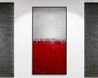 May include: Abstract art piece with a black frame, featuring a textured white upper half and a vibrant red lower half. The red section has a brushstroke effect, creating a dynamic visual contrast. The artwork is displayed on a white wall.