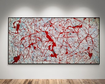 May include: Abstract painting with a black frame. The artwork features a white background with a network of red and black paint splatters and lines. The painting is displayed on a white wall above a wooden floor.