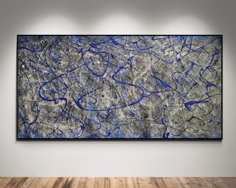 May include: Abstract expressionist painting with a black frame. The artwork features a gray and white background with blue and black paint splatters. The painting is rectangular and hangs on a white wall above a wooden floor.