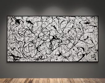 May include: A large rectangular wall art piece featuring a white background covered in a dense, chaotic network of thin and thick black paint splatters and drips, enclosed within a thin black frame that highlights the high-contrast abstract design.