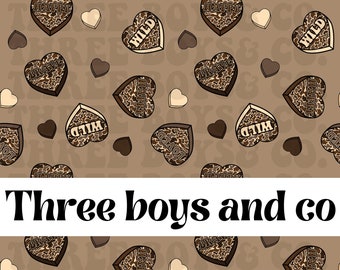 May include: A seamless pattern featuring brown hearts with various words like "WILD", "HAPPY", and "BRAVE" printed on them. The hearts are on a brown background with a subtle pattern. The text "Three boys and co" is printed below the pattern.