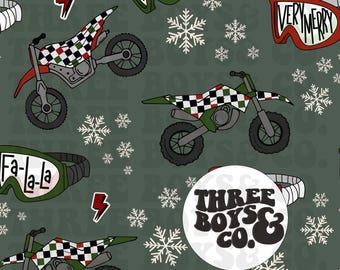 May include: A repeating pattern featuring motocross bikes with checkered flags, snowflakes, and goggles with the text "Fa-la-la" and "Very Merry" on a dark green background. The design includes a logo that says "Three Boys & Co."