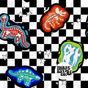 May include: A repeating pattern featuring dinosaur skeletons in red, blue, and green, set against a black and white checkered background. White stars are scattered throughout the design. A circular logo with the text "THREE BOYS & CO." is also present.