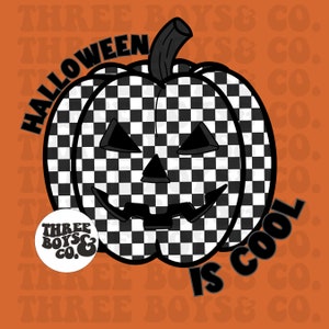 May include: A black and white checkered pumpkin with a carved jack-o'-lantern face. The pumpkin is surrounded by the text "Halloween is cool" and a logo that says "Three Boys & Co."