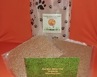 Peut inclure: Deux sacs en plastique transparents remplis de graines de blé, un petit sac blanc avec des empreintes de pattes noires et le texte "Eartha Kitty Cat Beds earthakittycat.com Sharing outdoors with your indoor cat" et une carte verte avec le texte "Eartha Kitty Cat Organic Wheatgrass".